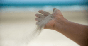 Hand letting go of sand