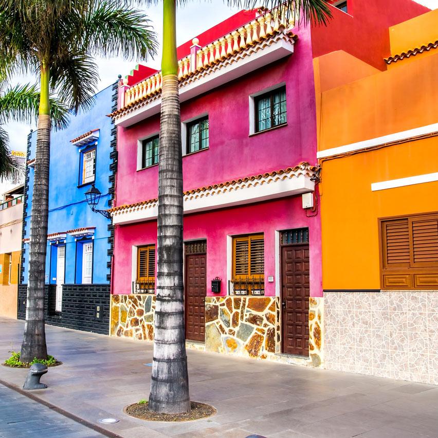 Tenerife. Colourful houses and palm trees on street in Puerto de la Cruz town, Tenerife, Canary Islands, Spain